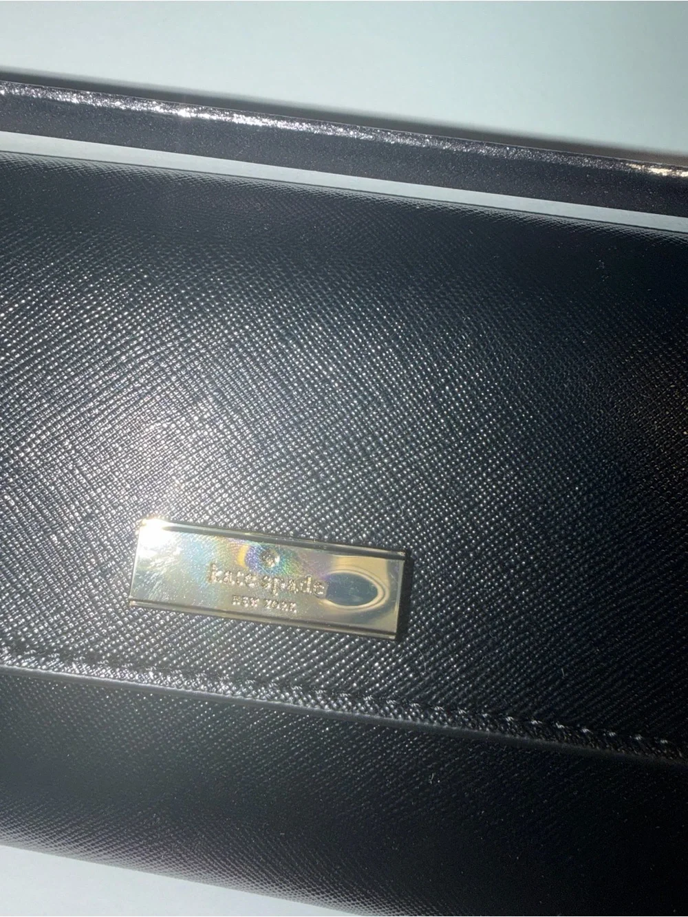 kate spade black saffiano leather flap wallet with gold plaque